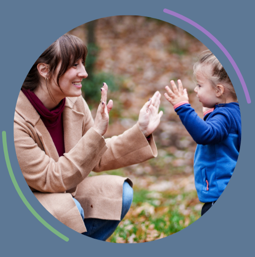 Woman and child playing hand-clap game outside