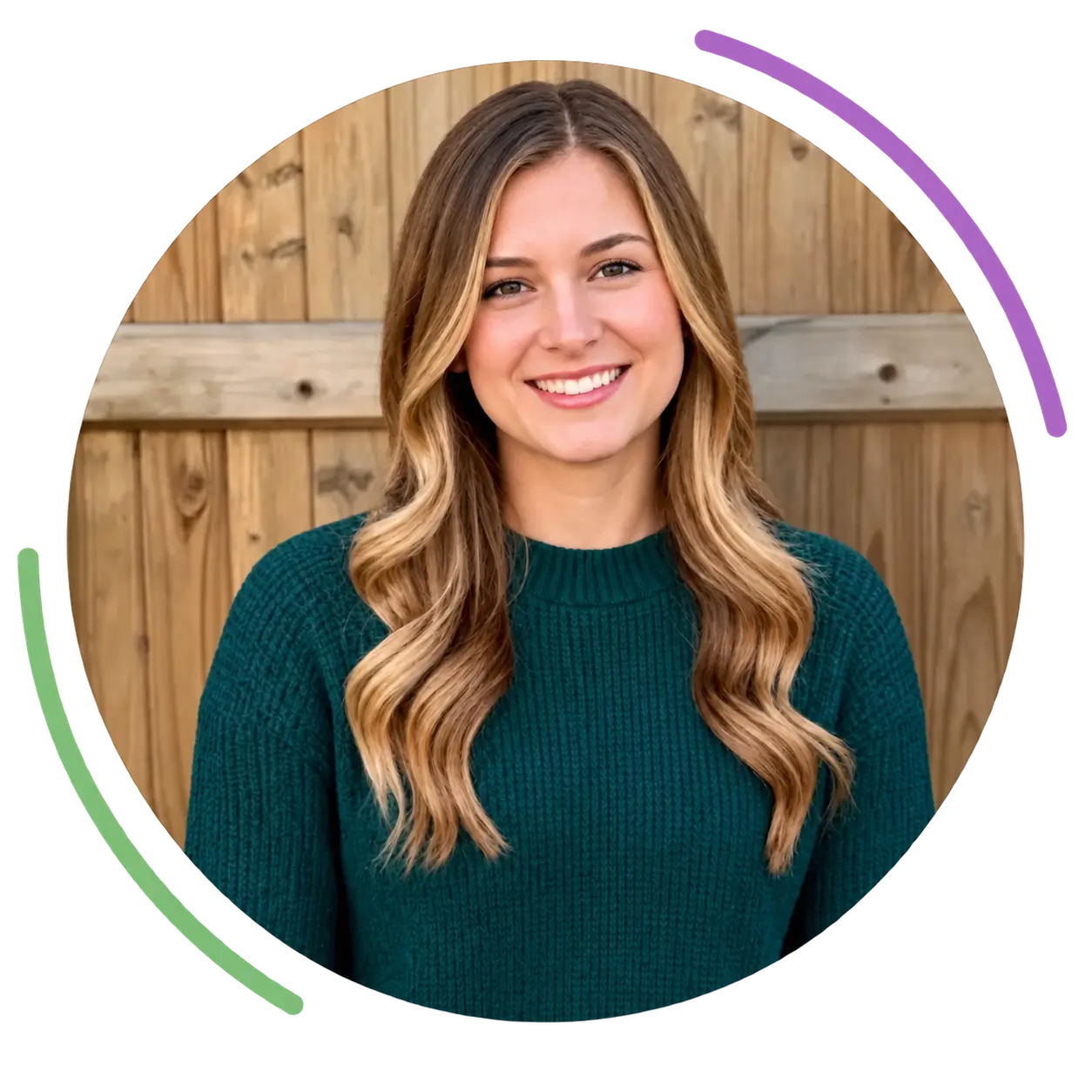 Smiling woman with long wavy hair wearing green sweater at Turnstone ABA therapy.